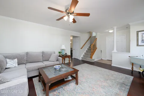 a living room with furniture and a wooden floor