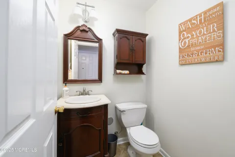 a bathroom with a toilet sink and mirror