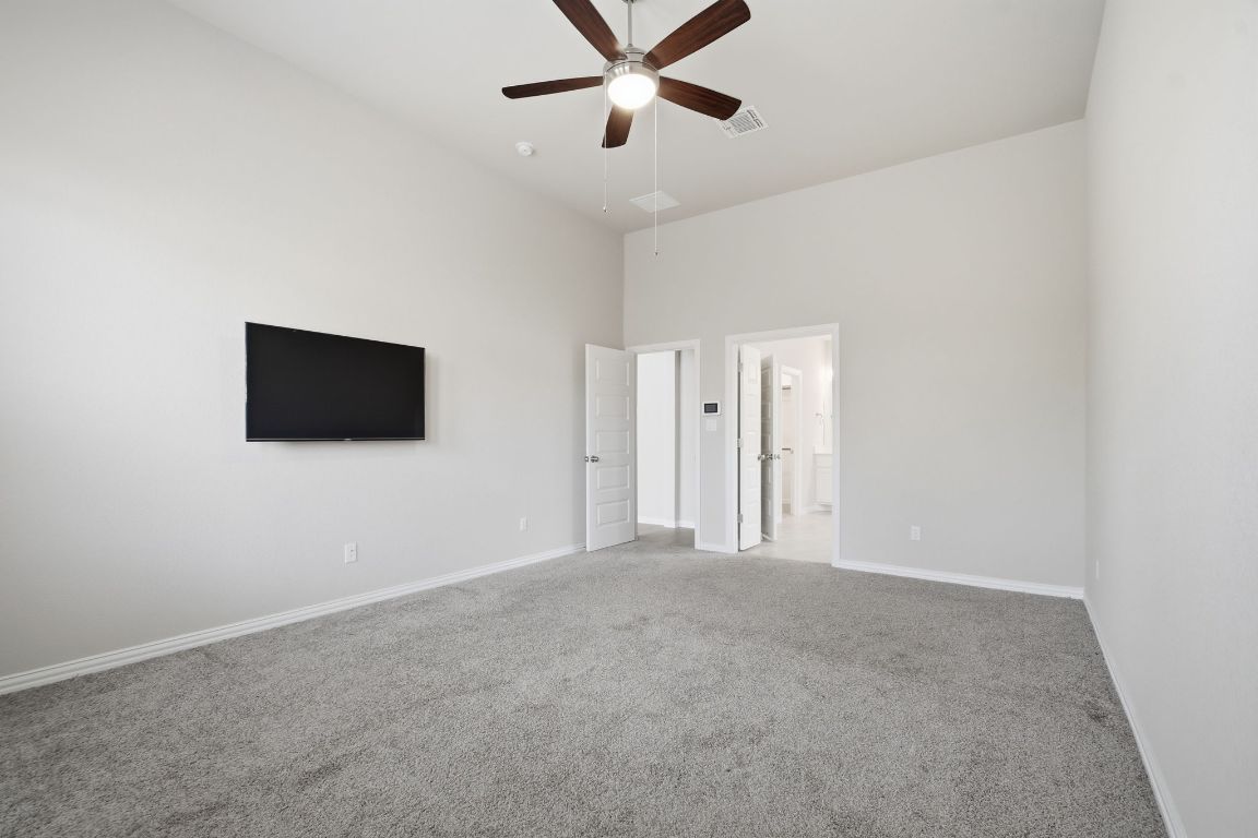 1009 Calendula Trail Georgetown, TX 78628 - Photo 16 of 31 a view of an empty room with a ceiling fan