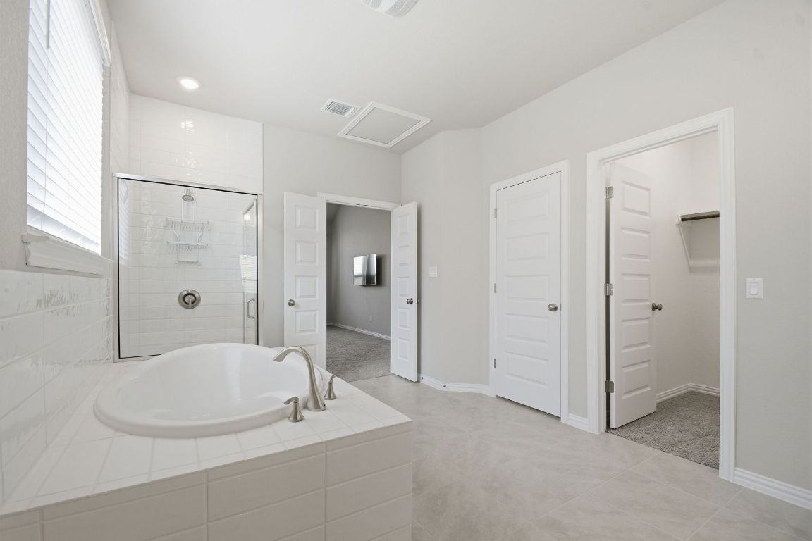 1009 Calendula Trail Georgetown, TX 78628 - Photo 18 of 31 a bathroom with a granite countertop sink a mirror and shower