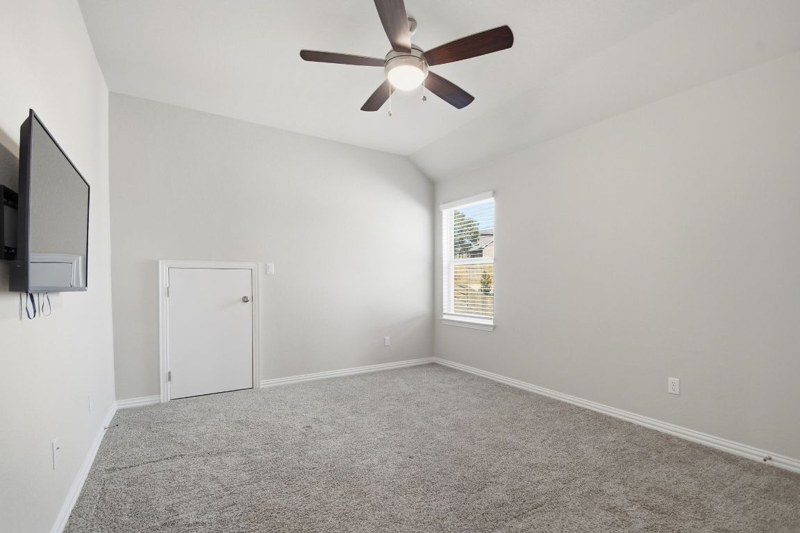 1009 Calendula Trail Georgetown, TX 78628 - Photo 24 of 31 an empty room with windows and fan