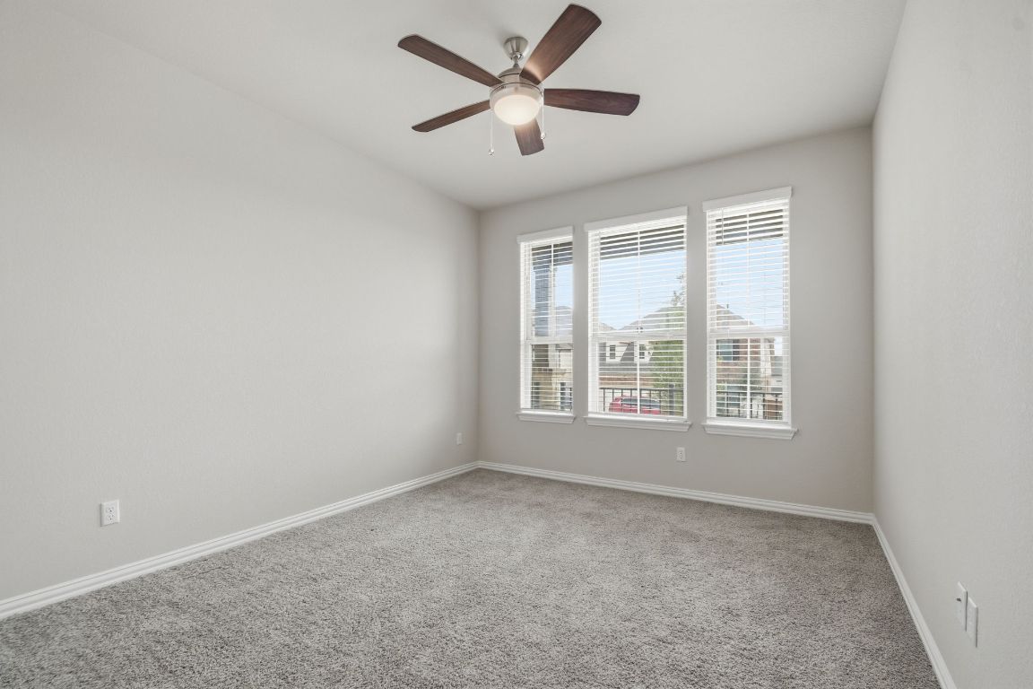 1009 Calendula Trail Georgetown, TX 78628 - Photo 9 of 31 a view of a livingroom with a ceiling fan and window