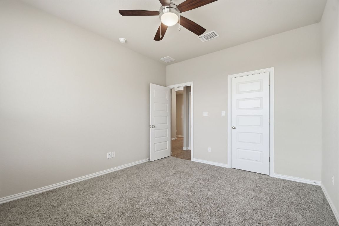 1009 Calendula Trail Georgetown, TX 78628 - Photo 10 of 31 a view of an empty room and chandelier fan