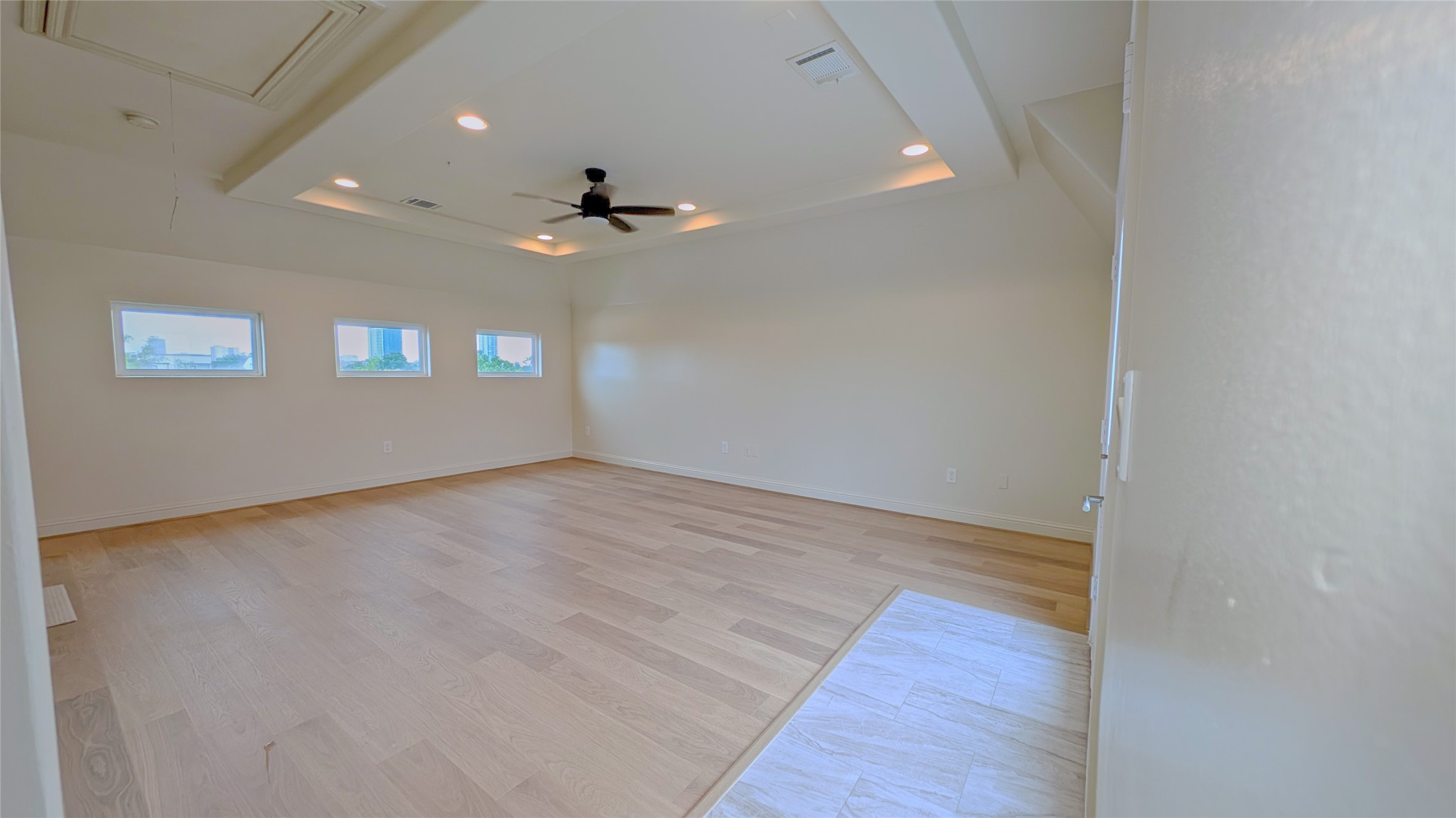1844 Colquitt Street Houston, TX 77098 - Photo 30 of 40 an empty room with wooden floor chandelier fan and windows