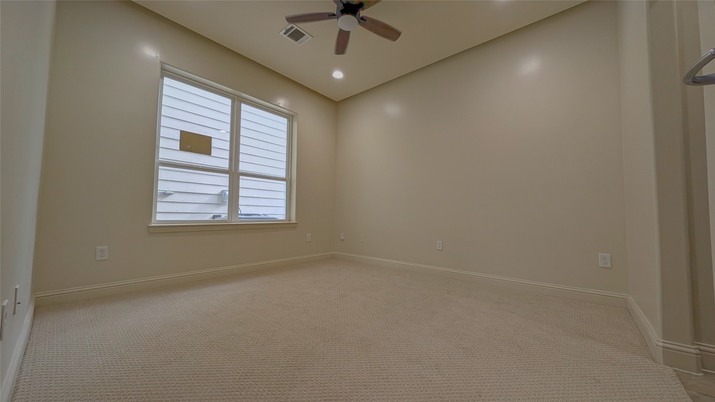 1844 Colquitt Street Houston, TX 77098 - Photo 6 of 40 an empty room with a ceiling fan and window