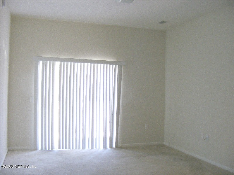 7920 Merrill Road, Unit 1607 Jacksonville, FL 32277 - Photo 4 of 16 an empty room with windows
