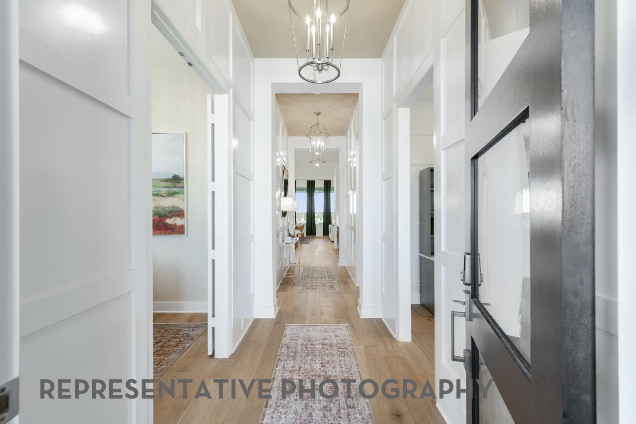 18918 Moonriver Street Conroe, TX 77302 - Photo 14 of 25 a view of a hallway with wooden floor and staircase