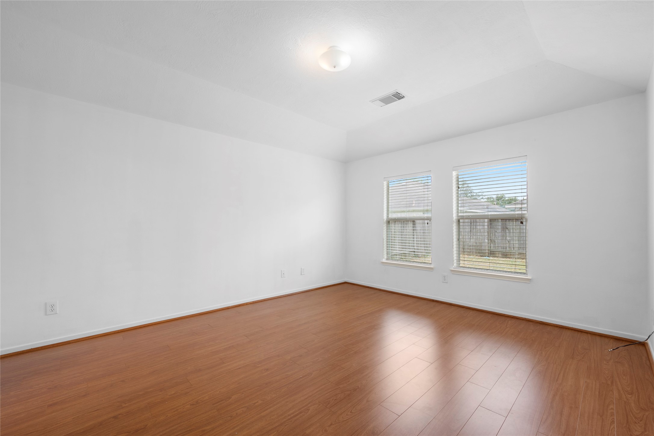 25211 Bluma Ranch Drive Katy, TX 77494 - Photo 11 of 22 a view of an empty room with wooden floor and a window