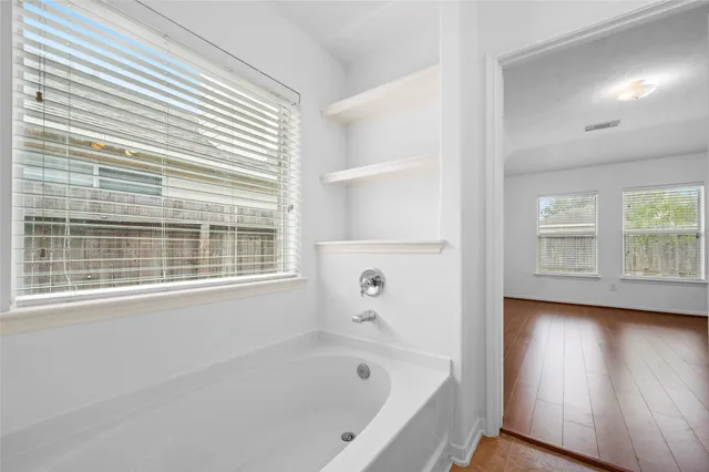 a white bath tub sitting next to a window