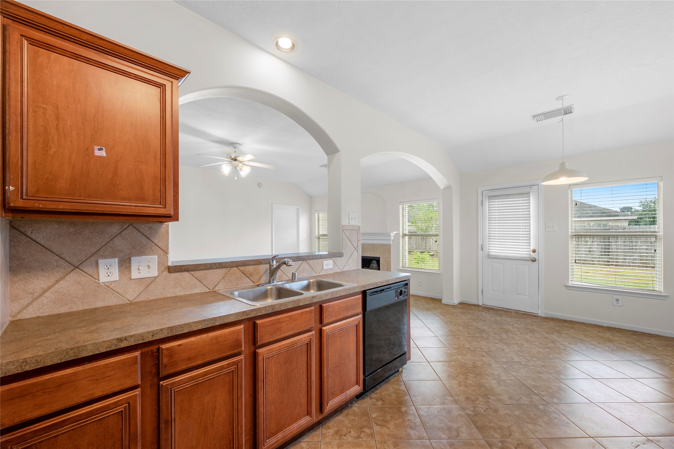 25211 Bluma Ranch Drive Katy, TX 77494 - Photo 8 of 22 a open kitchen with granite countertop a sink and dishwasher cabinets with wooden floor