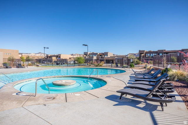 4845 Fishers Is Way St. George, UT 84770 - Photo 37 of 41 Community pool featuring a patio and a residential view