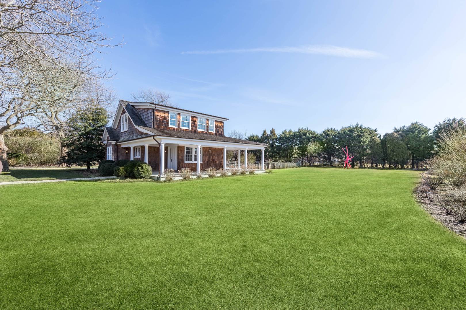 675 Flying Point Road Water Mill, NY 11976 - Photo 12 of 47 a front view of house with yard and green space