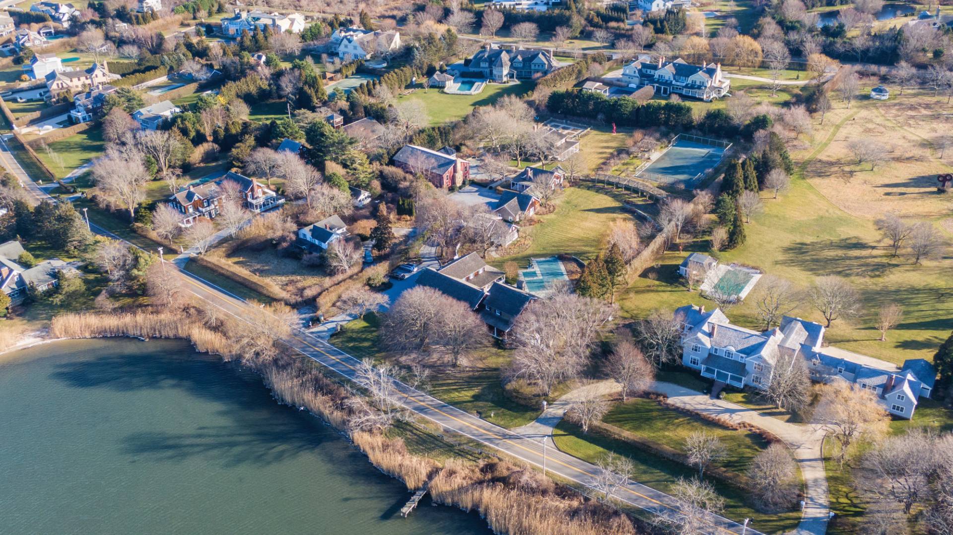 675 Flying Point Road Water Mill, NY 11976 - Photo 17 of 47 an aerial view of residential houses with outdoor space