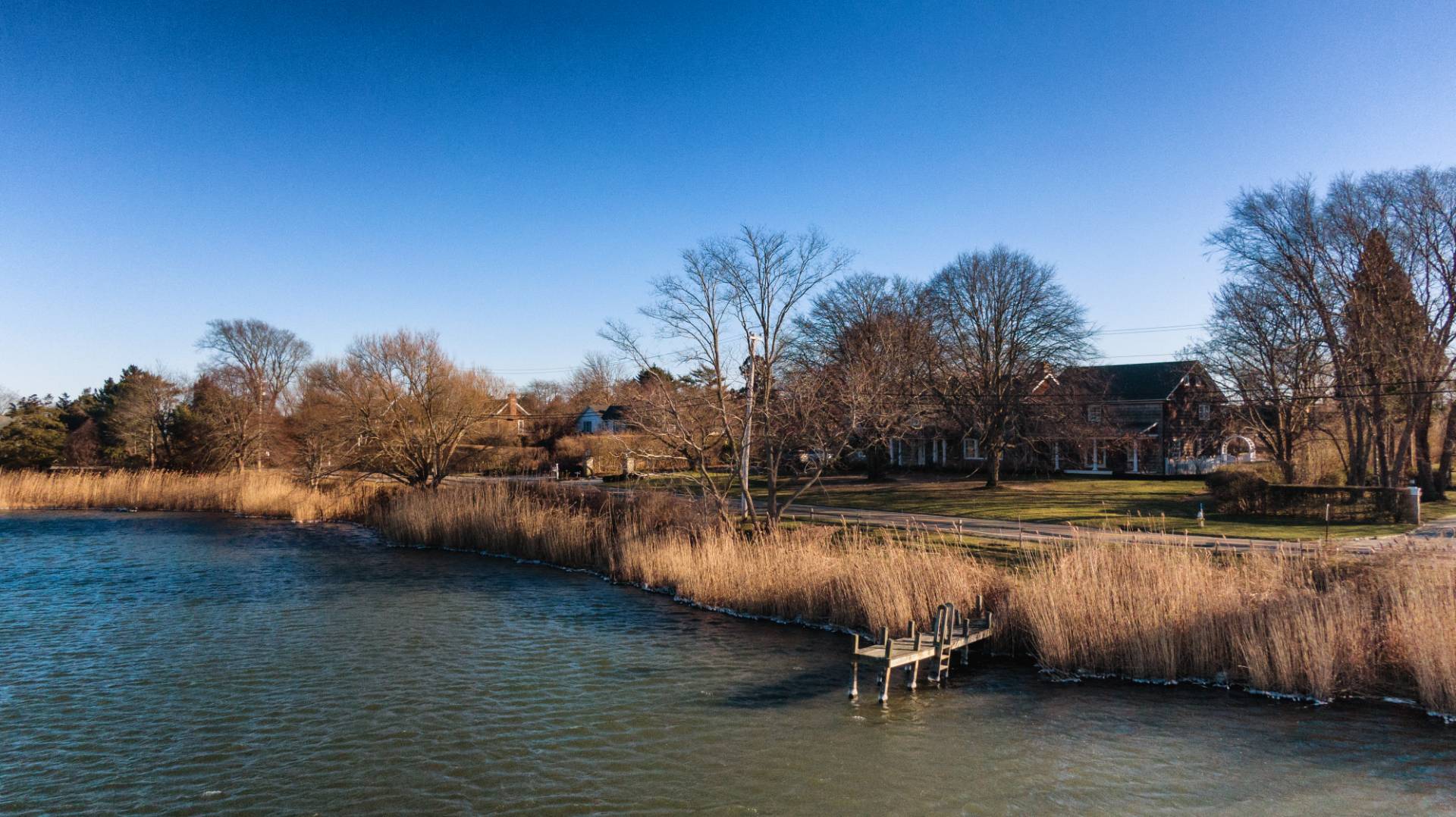 675 Flying Point Road Water Mill, NY 11976 - Photo 19 of 47 a view of a swimming pool with an outdoor space and seating area