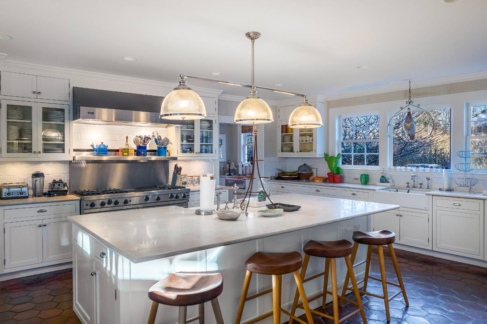 675 Flying Point Road Water Mill, NY 11976 - Photo 33 of 47 a kitchen with a stove a table and chairs in it