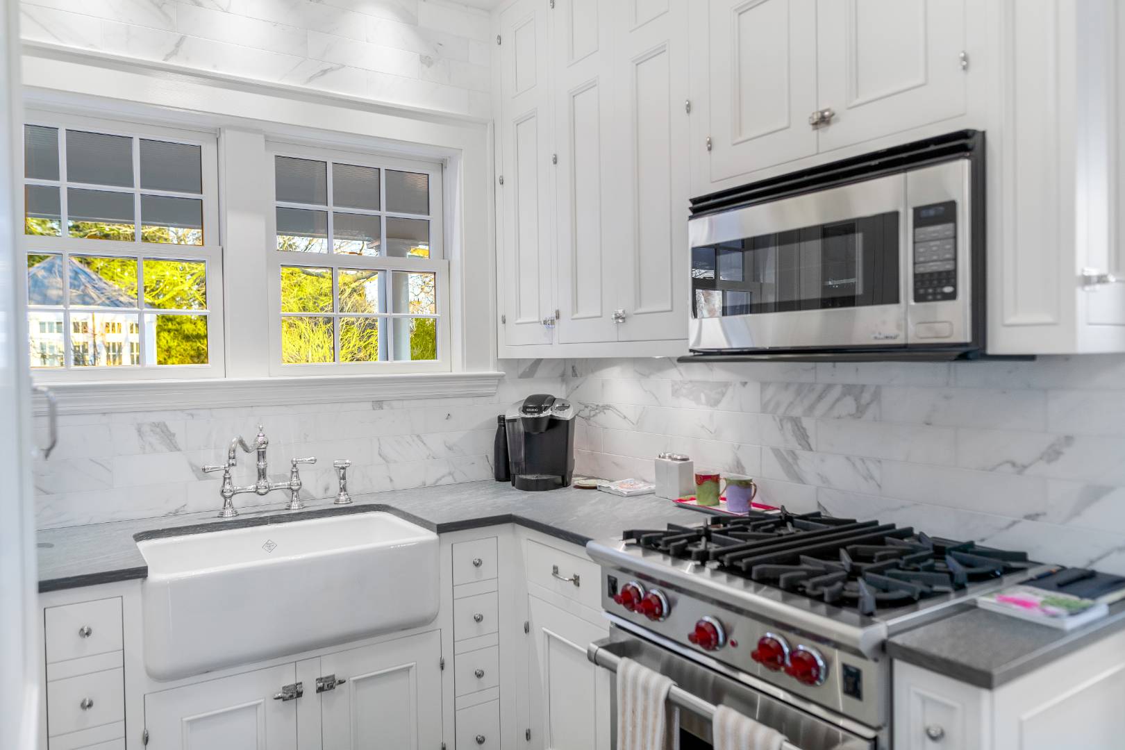 675 Flying Point Road Water Mill, NY 11976 - Photo 40 of 47 a kitchen with stainless steel appliances a stove a sink and a microwave
