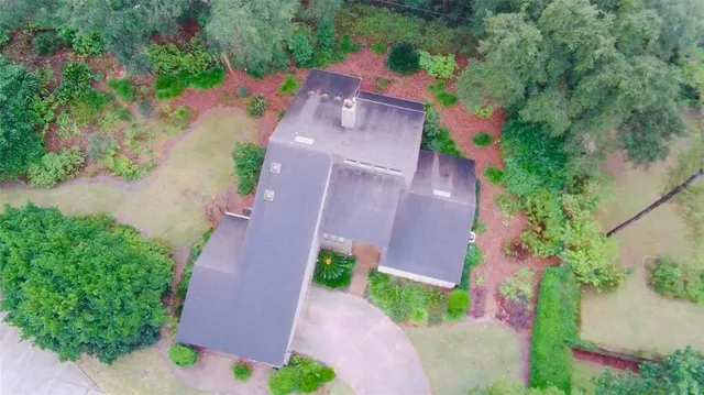 an aerial view of a house with a yard and garden