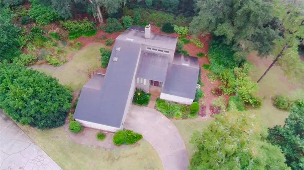 an aerial view of a house with a yard and garden