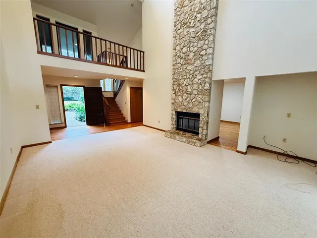 a view of a livingroom with an empty space and a fireplace