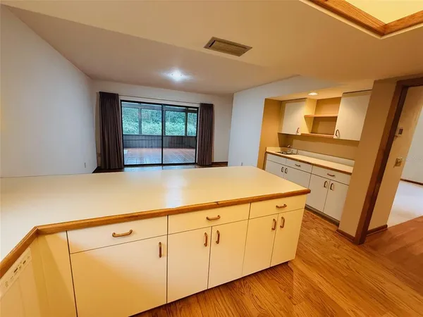 a kitchen with sink cabinets and wooden floor