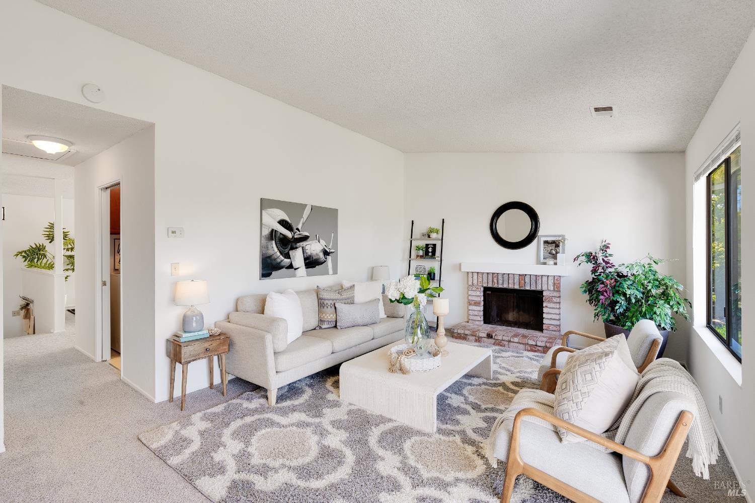 2000 Clearview Circle Benicia, CA 94510 - Photo 14 of 33 a living room with furniture a rug and a fireplace