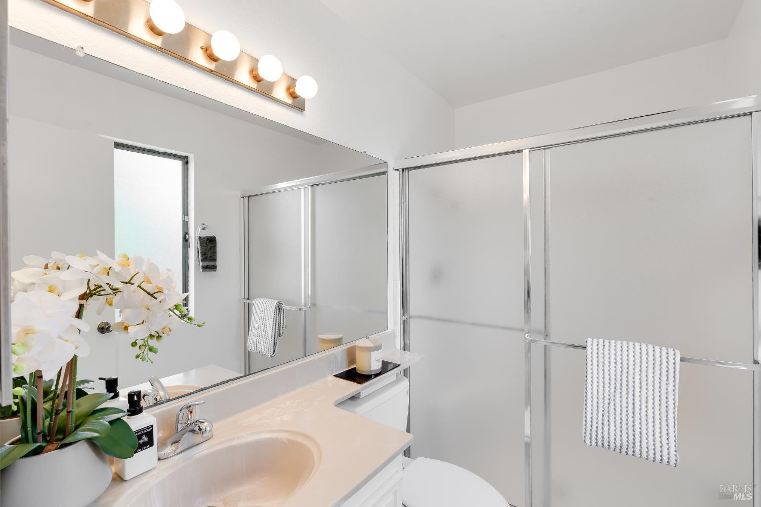 2000 Clearview Circle Benicia, CA 94510 - Photo 24 of 33 a bathroom with a sink a toilet a shower and a mirror