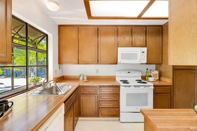 a kitchen with a sink stove and cabinets