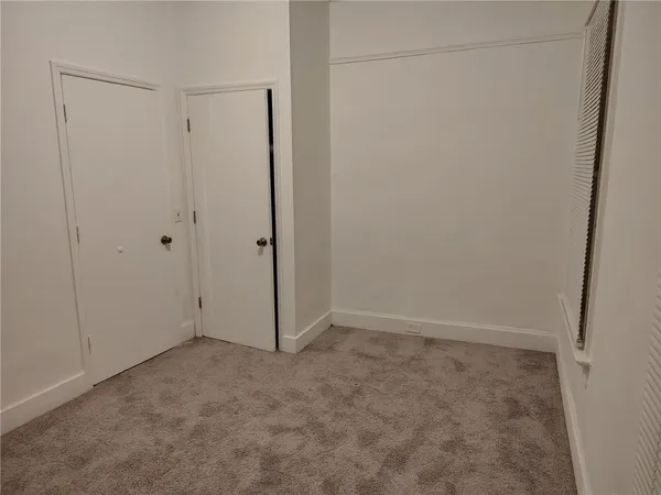 an empty room with closet area