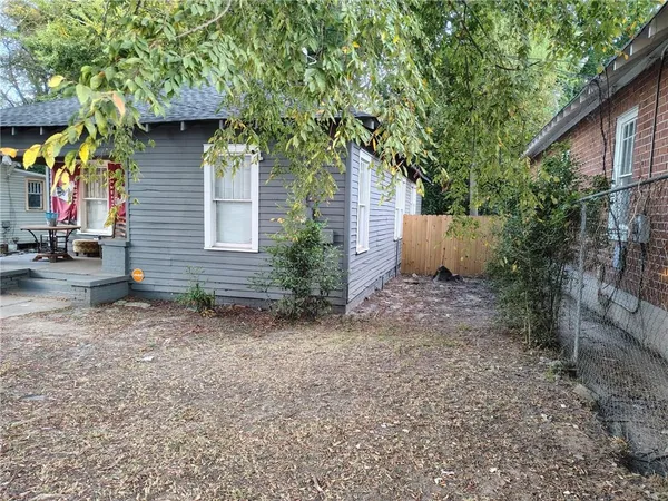 a backyard of a house with plants and trees