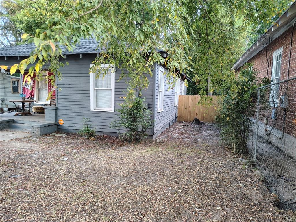 1112 32nd Street Columbus, GA 31904 - Photo 2 of 15 a backyard of a house with plants and trees