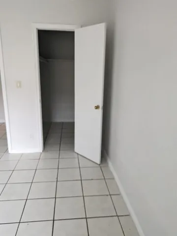 a view of a livingroom with an empty space and a window