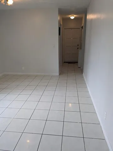 a view of a livingroom with a rug and a window