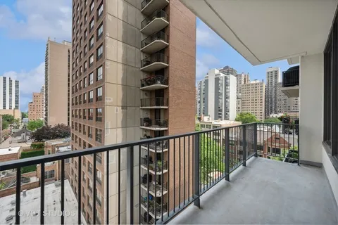 a view of a balcony with wooden floor and fence