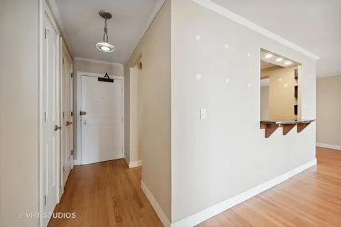 wooden floor fireplace and windows in an empty room