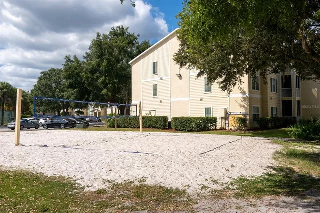 a white house that has a tree in front of it