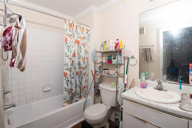 a white bath tub sitting next to a white sink and a white toilet