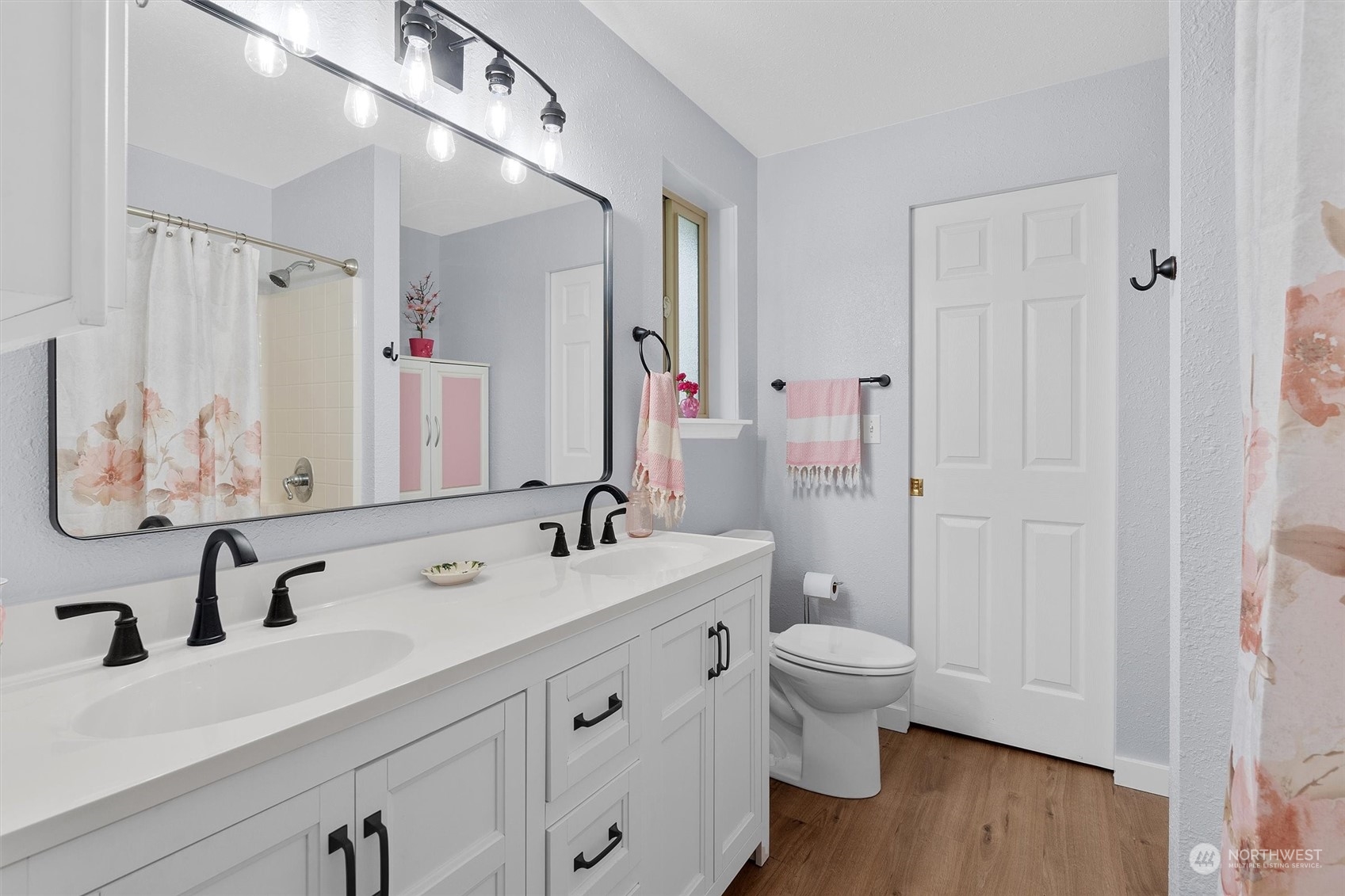 17545 Southeast 134th Street Renton, WA 98059 - Photo 16 of 40 a bathroom with a sink a toilet and a large mirror