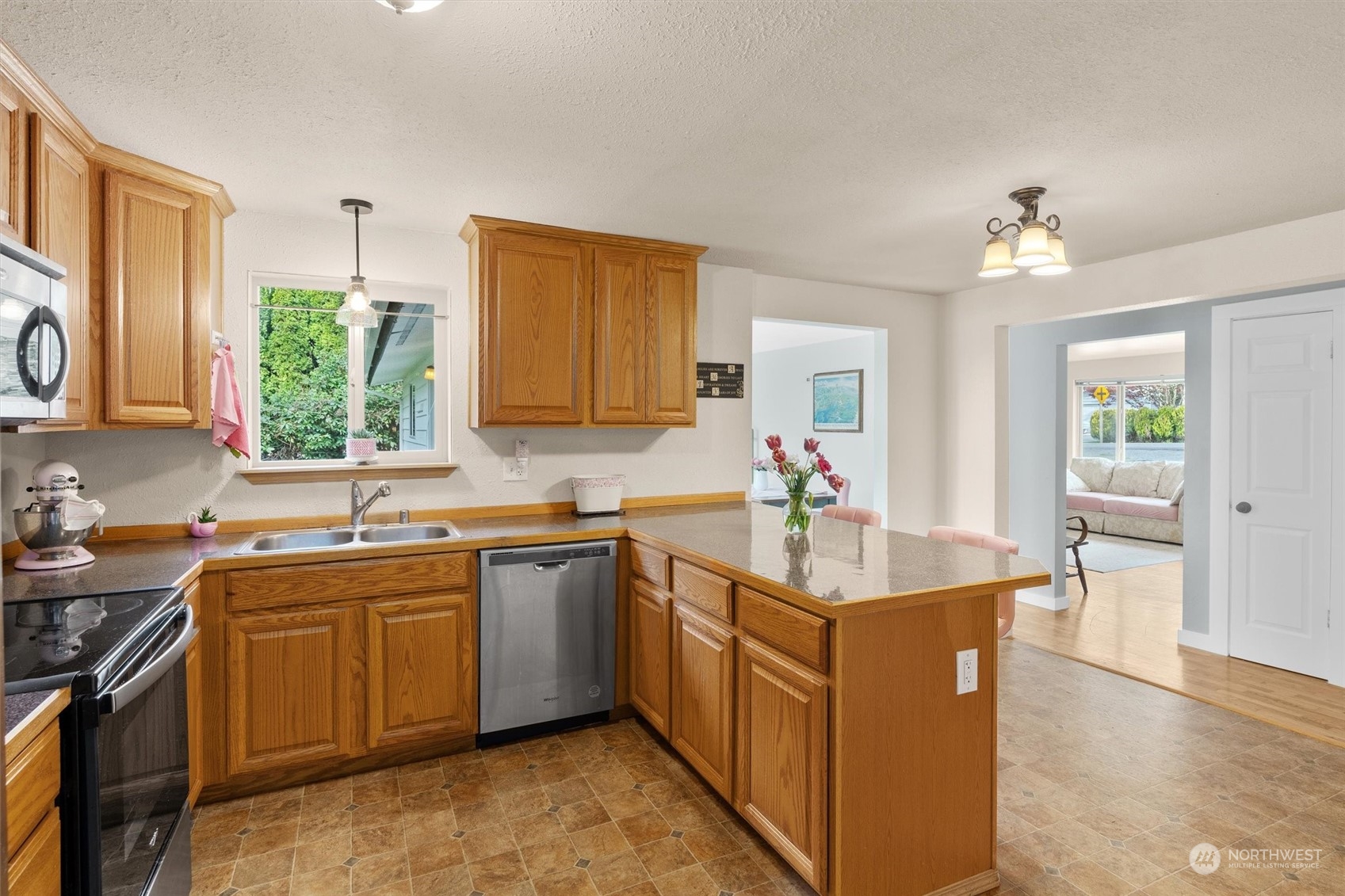 17545 Southeast 134th Street Renton, WA 98059 - Photo 7 of 40 a kitchen with stainless steel appliances granite countertop a sink stove and cabinets