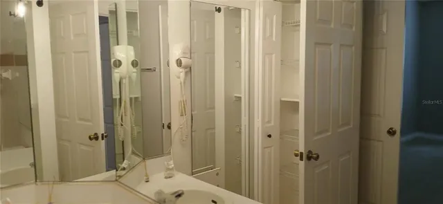 a bathroom with a shower and a sink