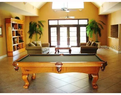 a living room with patio furniture and a large window