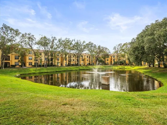 a view of a lake with houses in the background