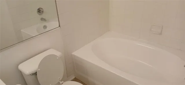 a bathroom with a bathtub and toilet
