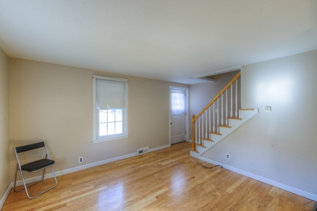 21 Marchioness Road Springfield, MA 01129 - Photo 12 of 38 a view of an empty room with wooden floor and a window