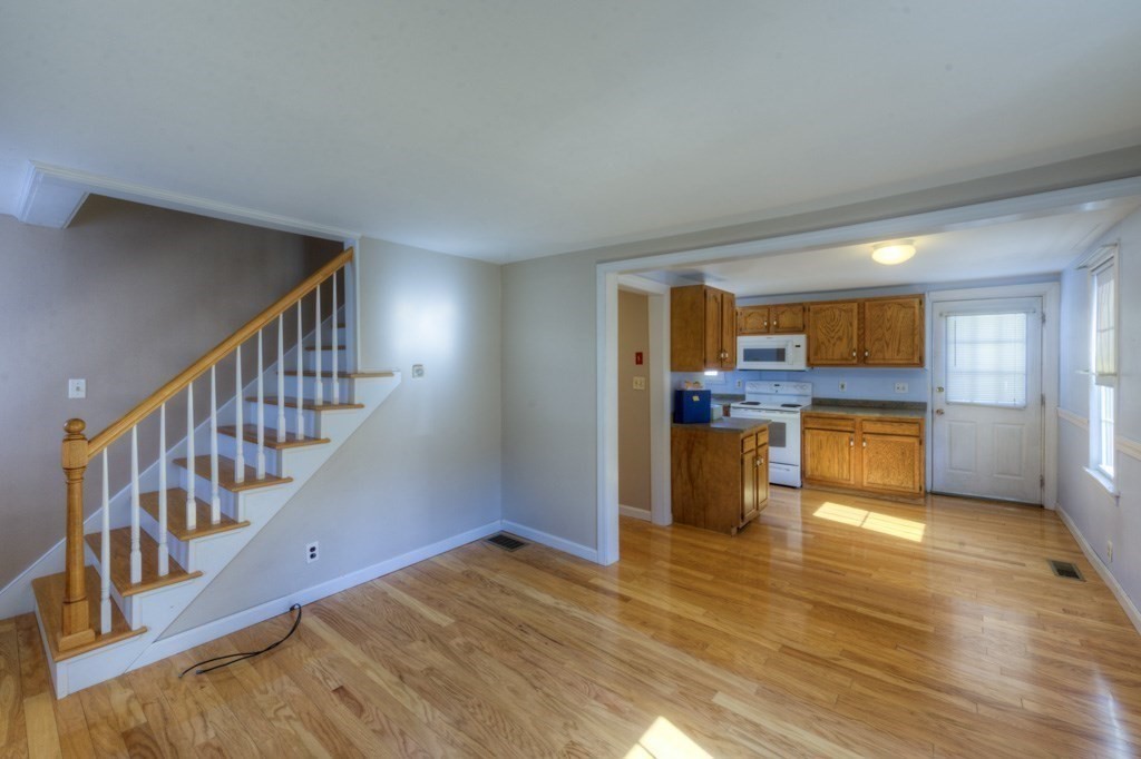 21 Marchioness Road Springfield, MA 01129 - Photo 4 of 38 a view of a kitchen and an empty room with wooden floor