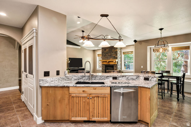 288 525 South Providence, UT 84332 - Photo 5 of 71 Kitchen island featuring a stainless steel sink, gooseneck faucet, light wood cabinetry, and a granite countertop
