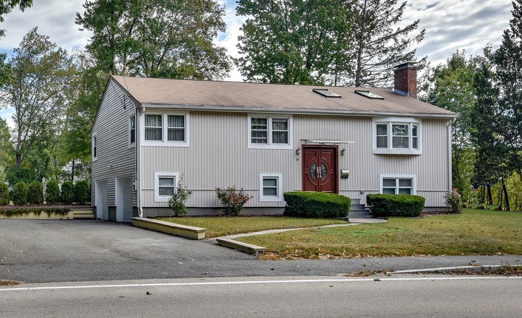20 Rutledge Road Natick, MA 01760 - Photo 2 of 29 a view of a white house with a small yard and large trees