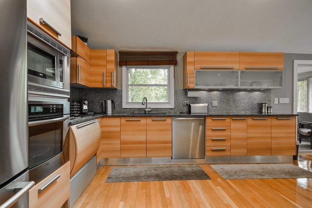 20 Rutledge Road Natick, MA 01760 - Photo 4 of 29 a kitchen with stainless steel appliances granite countertop a stove a sink and a microwave