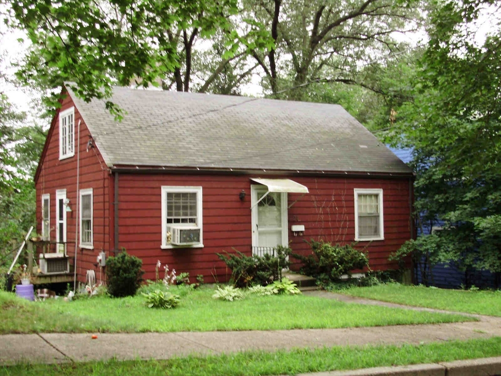 24 Roland Street Newton, MA 02461 - Photo 3 of 6 a front view of a house with a yard and garage