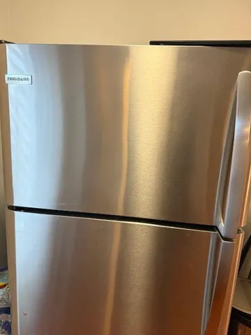 a kitchen with stainless steel appliances granite countertop a sink and a refrigerator