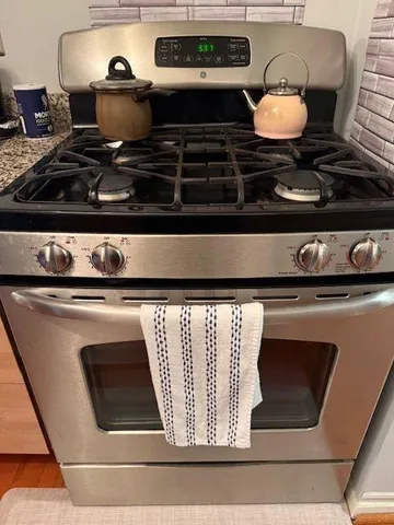 a stove top oven sitting inside of a kitchen